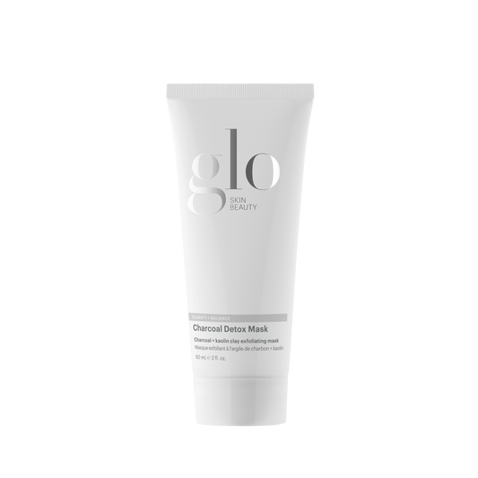 A white squeeze tube of glo beauty Charcoal Detox Mask centered on a plain white background.