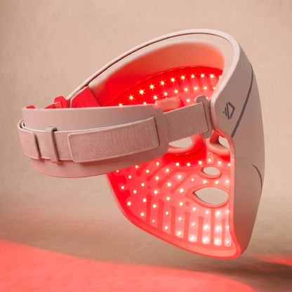 The inside of the Dermalux LED Face Mask, showing the array of individual LEDs lit red across the full face area